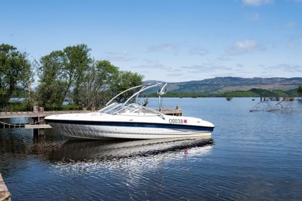 A motorboat tied up at the farm pier on calm water