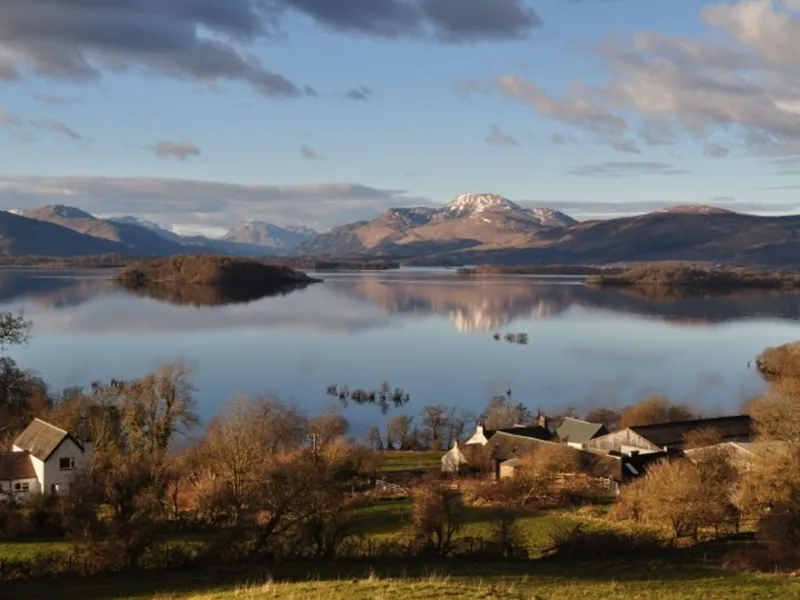 Autumn light on Loch Lomond, with hills across the water and buildings in the foreground