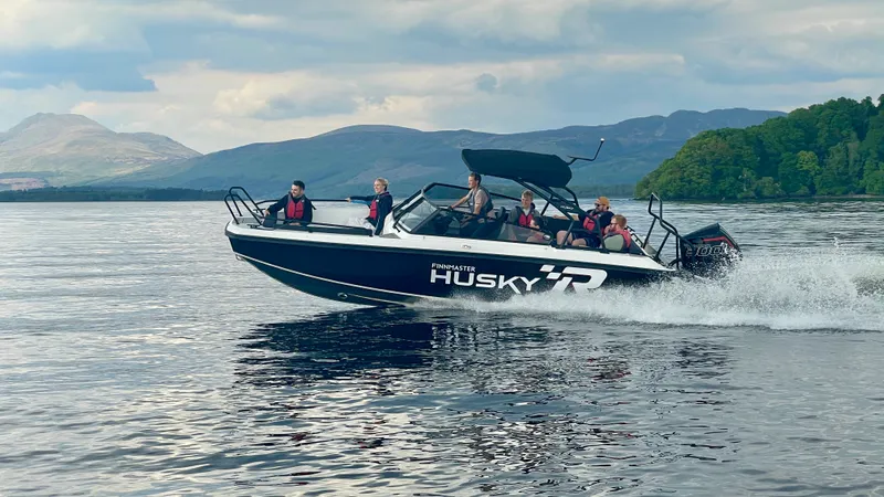 The Husky R8 speedboat at speed on Loch Lomond with six guests in life jackets