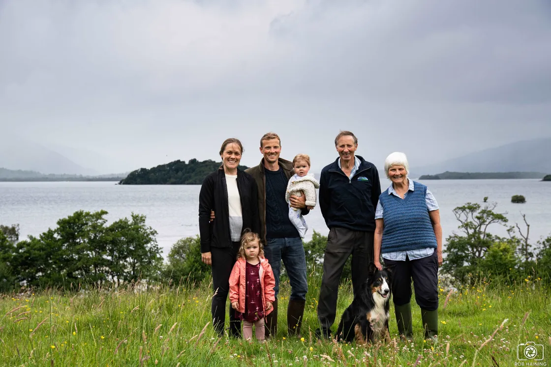 The Scott-Park family with their dog in a meadow above Loch Lomond